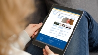 A woman looking at the Columbia Psychiatry news page on her tablet